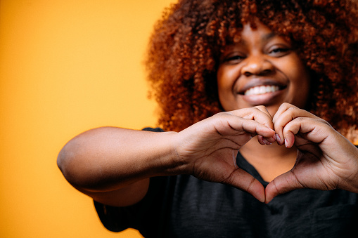 woman making a heart with hands